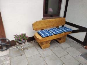 a wooden bench with blue cushions on a porch at Holiday Home Itzinger by Interhome in Ziesar