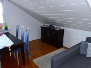 a living room with a table and a couch at Apartment ApartmentmitAusblick by Interhome in Wörth am Rhein