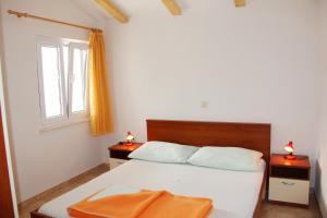 a bedroom with a bed with two night stands and a window at Vanda Seafront Superior in Cavtat