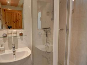 a white bathroom with a shower and a sink at Apartment Bastei by Interhome in Kurort Rathen