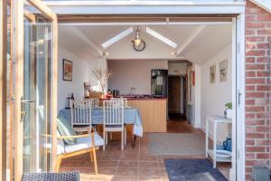 a dining room and kitchen with a table and chairs at 2 Bed in Aldeburgh oc-fsh in Aldeburgh +16 photos