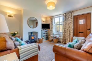 a living room with a couch and a fire place at 2 Bed in Aldeburgh oc-fsh in Aldeburgh