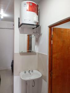 a bathroom with a toilet and a sink at Dpto Los Pinos in Fernández