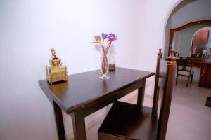 a vase of flowers sitting on a wooden table at Villa Silent Harbour in Bentota