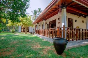 a building with a large pot in front of it at Villa Silent Harbour in Bentota +20 photos