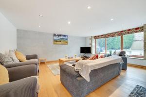 a living room with two couches and a tv at 4 Bed in High Peak oc-dcchb in Chinley
