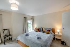 a bedroom with a bed and a chair and a window at 2 Bed in Reedham oc-c31116 in Haddiscoe