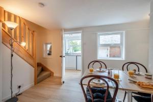 a dining room with a table and chairs and a staircase at 2 Bed in Reedham oc-c31116 in Haddiscoe +10 photos
