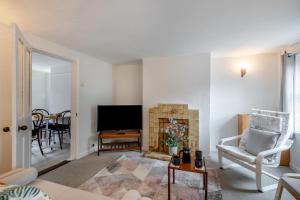 a living room with a fireplace and a television at 2 Bed in Reedham oc-c31116 in Haddiscoe