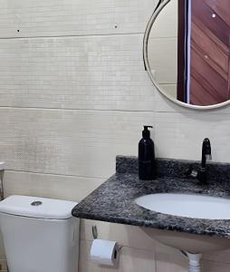 a bathroom with a sink and a mirror at Apartamento Cantinho do Mar in Natal +10 photos