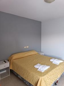 a bedroom with a bed with two towels on it at Clima Termal Suites in Federación +21 photos