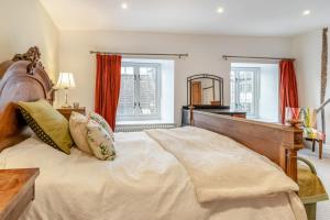 a bedroom with a large bed with a wooden headboard at 3 Bed in Trellech oc-j34206 in Trelleck