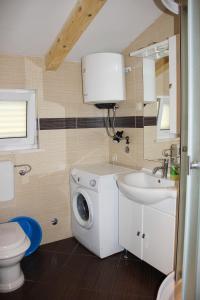 a bathroom with a washing machine and a sink at Vanda Seafront Superior in Cavtat