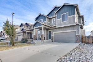 a large house with a garage on a driveway at Private Yard • BBQ • Patio • Sleeps 8 • 4BR in Colorado Springs