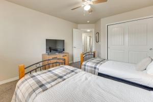 a bedroom with two beds and a kitchen at Private Yard • BBQ • Patio • Sleeps 8 • 4BR in Colorado Springs