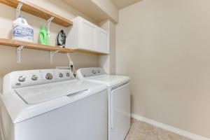a small laundry room with a washer and dryer at Private Yard • BBQ • Patio • Sleeps 8 • 4BR in Colorado Springs
