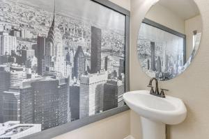 a bathroom with a sink and a window with a city at Private Yard • BBQ • Patio • Sleeps 8 • 4BR in Colorado Springs +23 photos