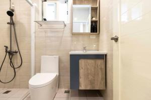 a bathroom with a toilet and a sink and a shower at T and C 民宿 in Wujie +43 photos