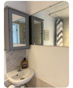 a bathroom with a sink and a mirror at Shangri-La in Chesham +12 photos