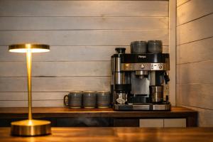 a coffee maker sitting on a table next to a lamp at La Casa Selva in Bocas Town