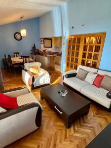 a living room with two couches and a table at Apartment Magdalena in Dobrota