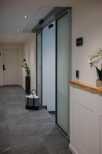 a hallway with glass doors in a building at ecHo Apartments & SPA in Bressanone