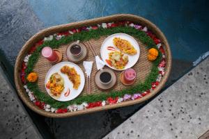 a table with plates of food on top at The Uma Tapan in Penginyahan