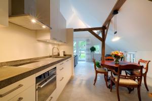 a kitchen with a table and chairs and a dining room at Op de Kuyerlatten in Zwolle