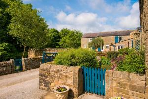 a blue fence in front of a house at Rowsley Cottage Bakewell Peak District in Bakewell