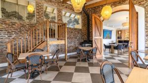 a restaurant with tables and chairs and a brick wall at Plettenvale Wines in Plettenberg Bay +143 photos