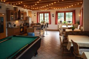 a room with a pool table in a restaurant at Pension Waldfrieden in Thale
