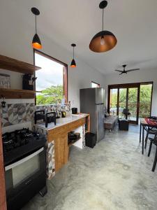 a kitchen with a stove and a counter top at CASA NANDOS Flat Essência !!! in Itacaré