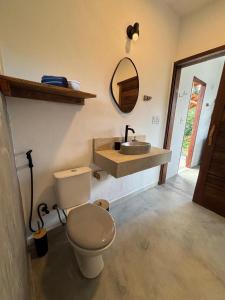 a bathroom with a toilet and a sink at CASA NANDOS Flat Essência !!! in Itacaré +37 photos