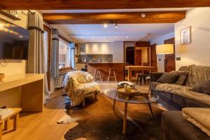 a living room with a couch and a table at Les Lauzes 32-46 in Mussillon