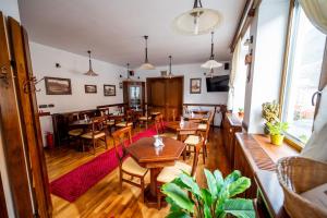 a restaurant with tables and chairs in a room at Pension Brasovu Vechi in Braşov