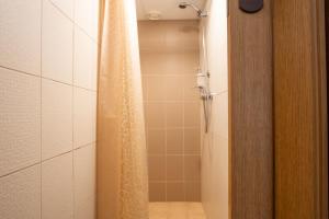 a bathroom with a shower with a shower curtain at Carolina Hotel in Pärnu +46 photos