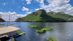 a view of a lake with a mountain in the background at Harties Boathouse in Hartbeespoort +10 photos