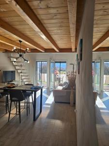 a dining room and living room with a table and chairs at marinella house 2 in Sarzana
