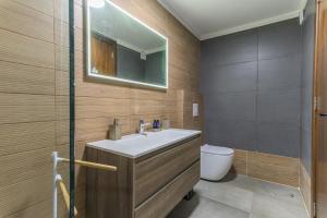 a bathroom with a sink and a toilet at Beautiful Studio in Faqra in Kfardebian +3 photos
