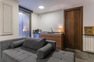 a living room with a couch and a kitchen at Beautiful Studio in Faqra in Kfardebian