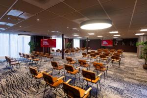a room with rows of chairs and tables in it at City Hotel Gouda, WorldHotels Crafted in Gouda