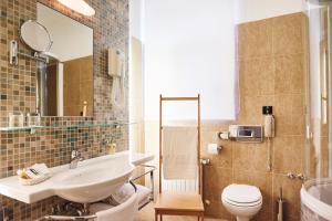 a bathroom with a sink and a toilet and a mirror at Hotel Villa Eugenia in Lovran +76 photos