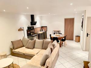 a living room with a couch and a table at Appartement cosy et confortable Chez Lyne in Laragne