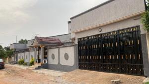 a building with a large black garage door at villa Eden in Vougomé