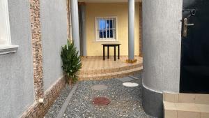 a door of a building with a table and a window at villa Eden in Vougomé +3 photos