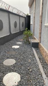 a side walk next to a building with a building at villa Eden in Vougomé