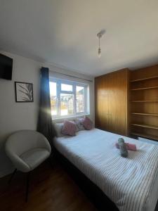 a bedroom with a bed with a stuffed animal on it at Urban Snooze in Herne Hill +4 photos