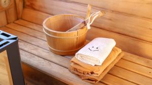a stack of towels next to a bucket in a sauna at Sokcho Biroso Private Cottage in Sokcho