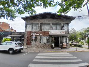 an old building on the corner of a street at Casa de Pedra Mineira in Canela