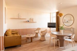 a living room with a table and chairs at Villa Chantereine in Cabourg